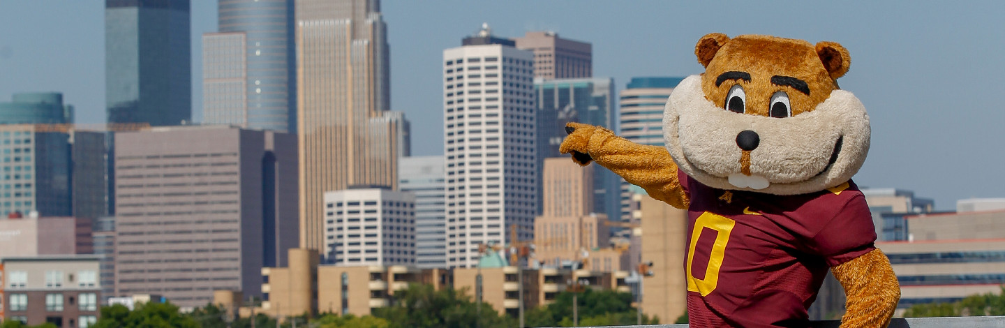 Goldy Gopher pointing at the Minneapolis skyline