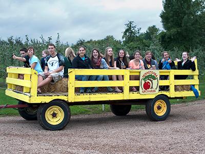 Students ride a hay wagon
