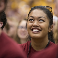 A student smiles while looking upwards